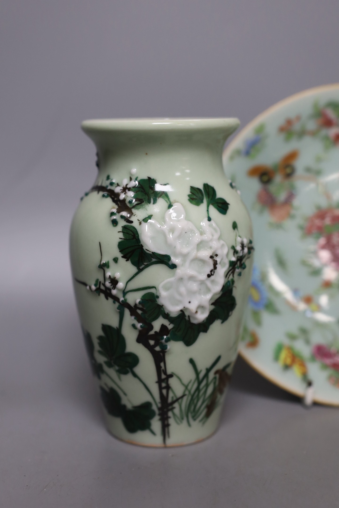 Three Chinese famille rose celadon ground plates and a pair of Japanese celadon ground vases